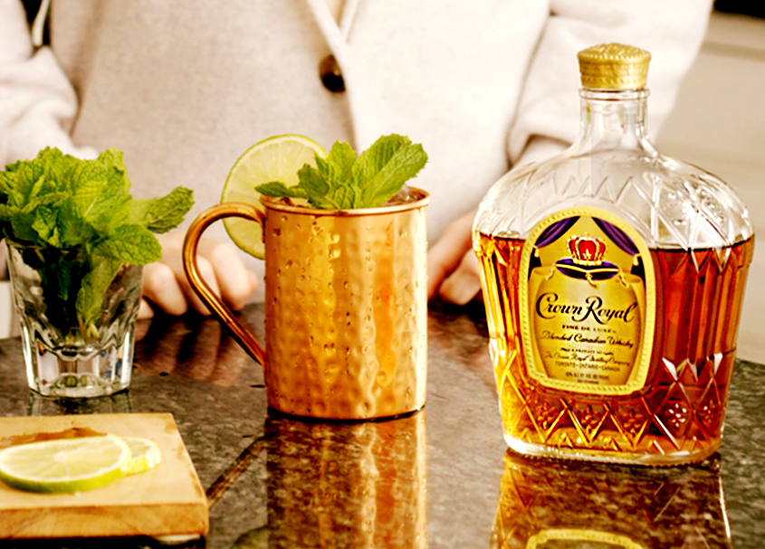 Quarter Back Deluxe Mule Whisky Cocktail with a bottle of Crown Royal Deluxe
